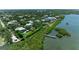 Aerial view of waterfront homes, private docks, and lush mangroves leading to tranquil open bay waters at 8963 Fishermens Bay Dr, Sarasota, FL 34231
