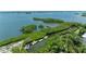 Aerial view showcases dock and lift with access to gulf at 8963 Fishermens Bay Dr, Sarasota, FL 34231