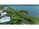 Stunning aerial view of waterfront homes with private docks and lush mangroves leading to the open bay at 8963 Fishermens Bay Dr, Sarasota, FL 34231