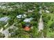 Overhead view of a house surrounded by tropical trees and manicured landscapes at 8963 Fishermens Bay Dr, Sarasota, FL 34231