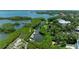 Aerial view of the private dock, canal, and lush landscaping showcasing waterfront living at 8963 Fishermens Bay Dr, Sarasota, FL 34231