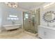This bathroom has a glass-enclosed shower, marble topped vanity, and clawfoot tub at 8963 Fishermens Bay Dr, Sarasota, FL 34231