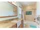 Well-lit bathroom features a tiled shower/tub and granite-topped vanity at 8963 Fishermens Bay Dr, Sarasota, FL 34231