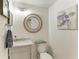 Well-lit half bath with marble sink, decorative mirror, and coastal decor at 8963 Fishermens Bay Dr, Sarasota, FL 34231