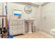 Classic bathroom with pedestal sink, vintage mirror and storage cabinet at 8963 Fishermens Bay Dr, Sarasota, FL 34231