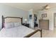 Comfortable bedroom features a walk-in closet, ceiling fan, and bedside table at 8963 Fishermens Bay Dr, Sarasota, FL 34231