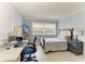 Inviting bedroom featuring light walls, hardwood floors, and a large window at 8963 Fishermens Bay Dr, Sarasota, FL 34231