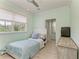 Bright bedroom has nice window views, ceiling fan, and a wooden dresser at 8963 Fishermens Bay Dr, Sarasota, FL 34231