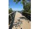A scenic boardwalk with wooden railings overlooking a calm body of water, perfect for leisurely strolls at 8963 Fishermens Bay Dr, Sarasota, FL 34231