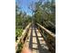 Inviting waterfront boardwalk offering a scenic pathway through a lush, natural environment at 8963 Fishermens Bay Dr, Sarasota, FL 34231