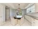 Bright dining area featuring a round table, statement chandelier, and sliding glass doors to the outside at 8963 Fishermens Bay Dr, Sarasota, FL 34231