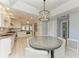 Open floor plan showcases a dining area with a large round table and upholstered chairs at 8963 Fishermens Bay Dr, Sarasota, FL 34231
