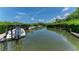 Private dock with boat lift offering direct waterfront access and scenic views at 8963 Fishermens Bay Dr, Sarasota, FL 34231