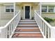Home featuring front steps and porch with decorative accents at 8963 Fishermens Bay Dr, Sarasota, FL 34231