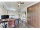 Bright home office features hardwood floors, ceiling fan, built-in Murphy bed, and office desk at 8963 Fishermens Bay Dr, Sarasota, FL 34231