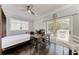 Bright home office includes a desk and an exterior sliding glass door leading to a deck at 8963 Fishermens Bay Dr, Sarasota, FL 34231