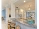 Kitchen bar area with stone counters, seating, and adjacent dining area at 8963 Fishermens Bay Dr, Sarasota, FL 34231