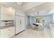 Eat-in kitchen with modern appliances, white cabinets, and adjacent dining area at 8963 Fishermens Bay Dr, Sarasota, FL 34231