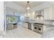 Modern kitchen with stainless steel appliances, white subway tile, and adjacent breakfast nook at 8963 Fishermens Bay Dr, Sarasota, FL 34231