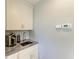 Butler's pantry featuring marble counters, sink, and built-in coffee bar at 8963 Fishermens Bay Dr, Sarasota, FL 34231
