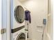 The laundry area has a stacked washer/dryer in a small, well-lit area at 8963 Fishermens Bay Dr, Sarasota, FL 34231