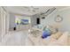 Spacious living room featuring modern decor, comfortable seating, a large TV, and plenty of natural light at 8963 Fishermens Bay Dr, Sarasota, FL 34231