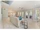 Bright and airy living room featuring light wood floors, neutral furniture, and access to outdoor spaces at 8963 Fishermens Bay Dr, Sarasota, FL 34231