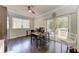 Office area with hardwood floors, ceiling fan, desk, natural light, and access to balcony at 8963 Fishermens Bay Dr, Sarasota, FL 34231