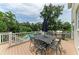 Outdoor patio showcasing a dining set, grill, and view of the swimming pool amidst lush landscaping at 8963 Fishermens Bay Dr, Sarasota, FL 34231
