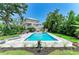 Inviting backyard featuring a refreshing pool, lounging area, and a picturesque view of the home at 8963 Fishermens Bay Dr, Sarasota, FL 34231