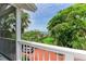 Covered porch showing lush greenery, with views of the water and a brick driveway at 8963 Fishermens Bay Dr, Sarasota, FL 34231