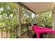 Relax on the porch with dining set, lush greenery, and privacy at 8963 Fishermens Bay Dr, Sarasota, FL 34231