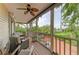 Large porch with outdoor seating, offering views of a brick driveway and lush landscaping at 8963 Fishermens Bay Dr, Sarasota, FL 34231