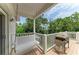 Charming porch with a swing and BBQ grill, perfect for enjoying the outdoors and tropical views at 8963 Fishermens Bay Dr, Sarasota, FL 34231