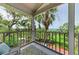 Enjoy views of lush greenery from this screened porch, complete with comfortable seating and a decorative rug at 8963 Fishermens Bay Dr, Sarasota, FL 34231