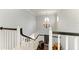 Staircase with white railings and black trim, bathed in natural light at 8963 Fishermens Bay Dr, Sarasota, FL 34231