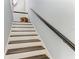 Wooden staircase with white risers and dark wood treads at 8963 Fishermens Bay Dr, Sarasota, FL 34231