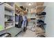 Well-organized walk-in closet with multiple shelves and hanging rods for efficient storage at 8963 Fishermens Bay Dr, Sarasota, FL 34231
