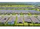 A high angle aerial image of a neighborhood of homes with a central lake at 926 Fernleaf Run, Bradenton, FL 34212