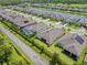 Birds-eye view of home with a well-maintained lawn, landscaping, and a community lake at 926 Fernleaf Run, Bradenton, FL 34212