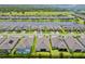 A high angle aerial image of a neighborhood of homes with a central lake at 926 Fernleaf Run, Bradenton, FL 34212