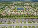 An aerial shot showcases the community with a central lake, a fountain, and picturesque homes at 926 Fernleaf Run, Bradenton, FL 34212