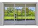 View of the backyard from inside the home, showing a patio and lush greenery at 926 Fernleaf Run, Bradenton, FL 34212