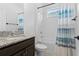 Bathroom featuring granite countertop, white tub and shower with blue shower curtain at 926 Fernleaf Run, Bradenton, FL 34212