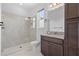 Bathroom featuring a tiled walk-in shower with glass door, modern fixtures, and vanity with granite countertops at 926 Fernleaf Run, Bradenton, FL 34212