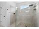 Modern bathroom with a glass-enclosed shower featuring decorative tile and a rain shower head at 926 Fernleaf Run, Bradenton, FL 34212