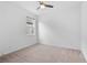 Neutral carpeted bedroom with a ceiling fan and window at 926 Fernleaf Run, Bradenton, FL 34212