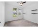 Bedroom featuring neutral carpet, floating shelves, and two large windows at 926 Fernleaf Run, Bradenton, FL 34212