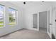 Bright bedroom with neutral carpet, ceiling fan, and glass paneled doors at 926 Fernleaf Run, Bradenton, FL 34212