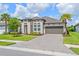 Charming one-story home with a paver driveway, two-car garage, and a well-manicured lawn at 926 Fernleaf Run, Bradenton, FL 34212